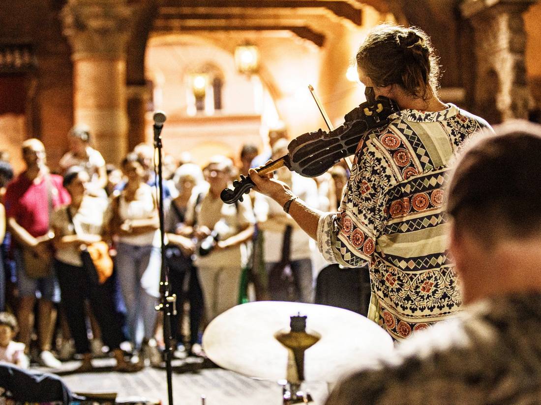 Ferrara Buskers Festival, street musicians performing for a crowd in Ferrara, Italy