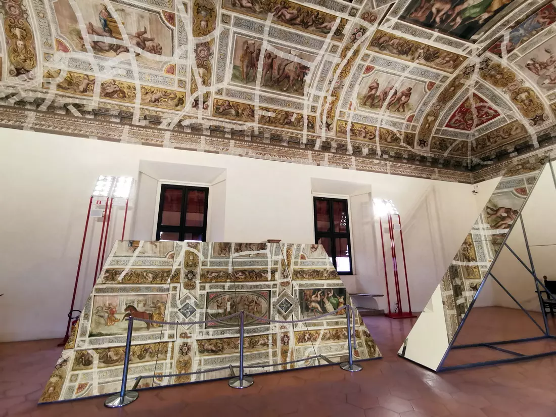 Painted ceiling reflected in large mirrors inside the castle