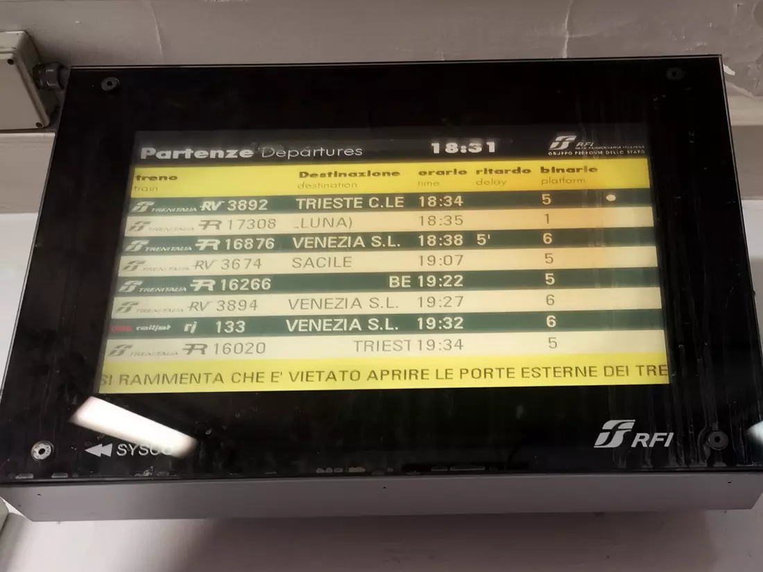Train timetable at Ferrara railway station, Italy