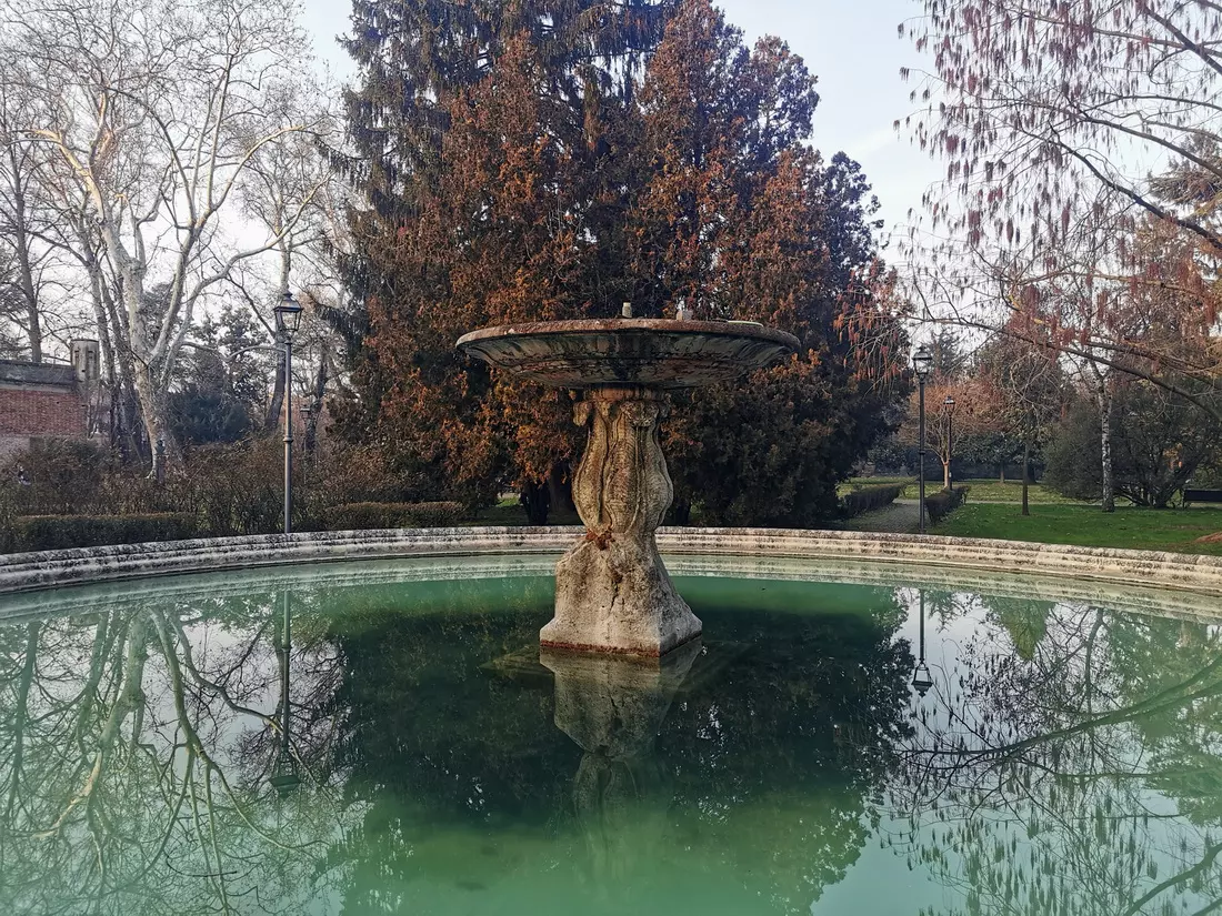 Massari Park with trees and fountain in Ferrara, Italy