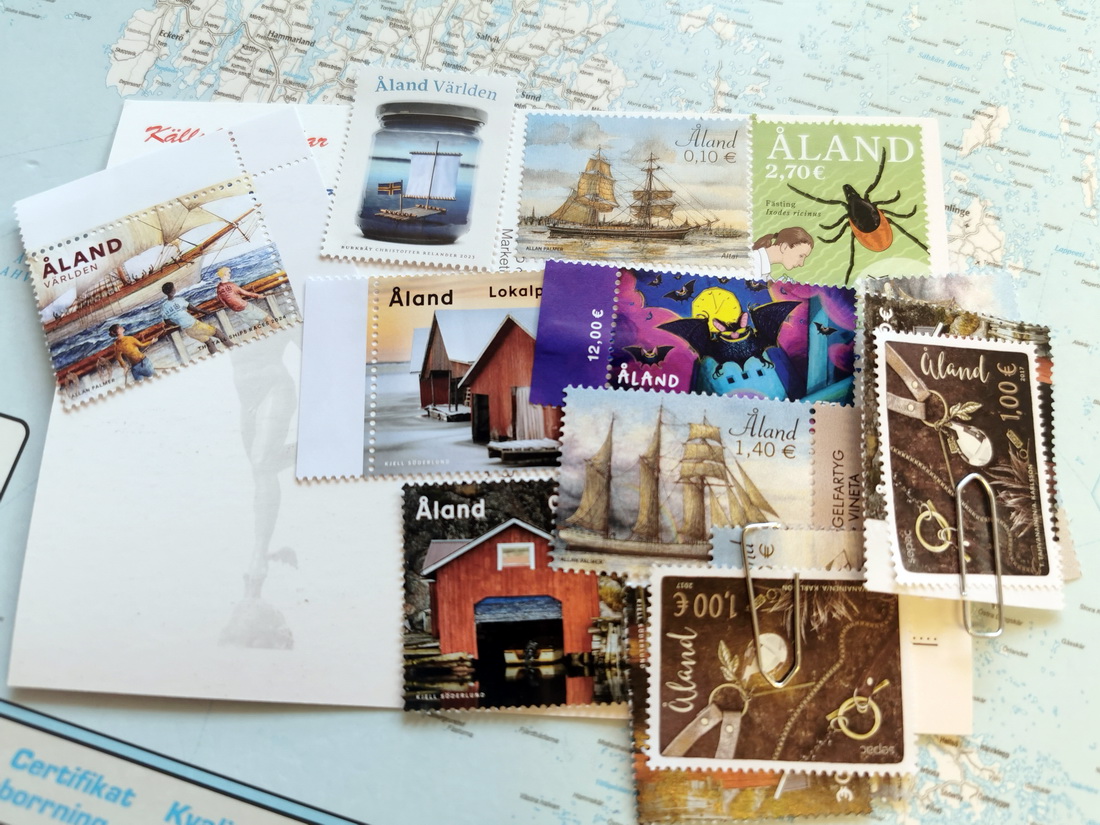 Åland stamps featuring a red boathouse and a tick