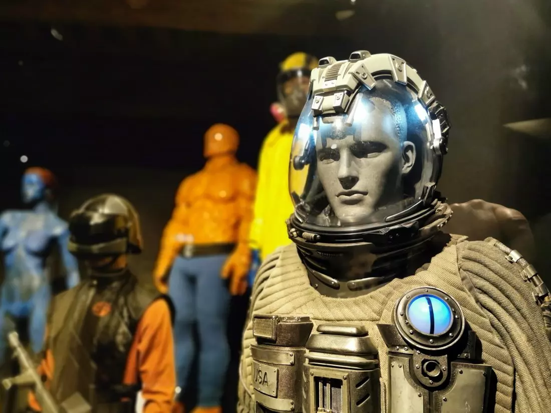 Film costume display at the Museum of Cinema and Miniatures in Lyon, featuring sci-fi and superhero outfits from various movies.