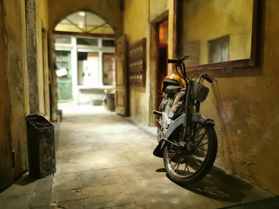 Detailed miniature of a city alley with a motorbike at the Museum of Miniatures in Lyon