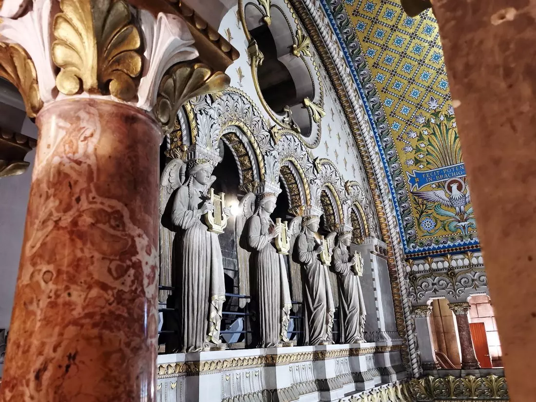 Interior of the Basilica of Fourvière with colourful mosaics and ornate details.