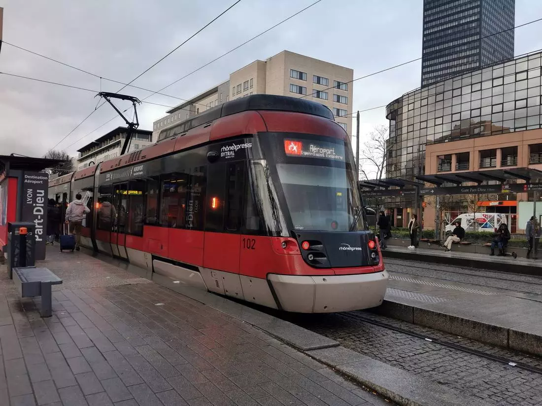 Rhônexpress tram waiting at Lyon Part-Dieu station platform, heading to Lyon-Saint Exupéry Airport.