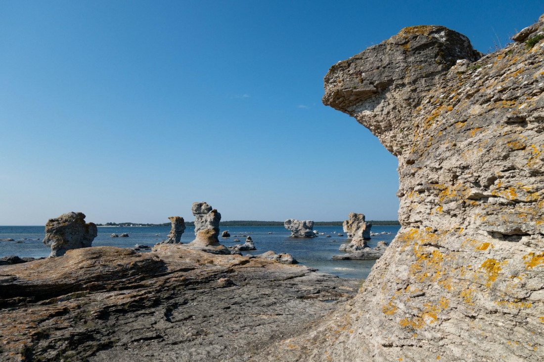 Baltic Sea Islands, Fårö, Gotland — stunning rock formations along the coastline with clear blue water and a bright sky.