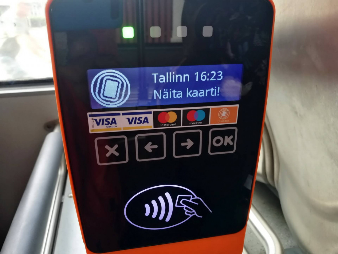 Contactless ticket validator on a Tallinn public bus, showing card payment option for transport from Tallinn Airport to the city centre.