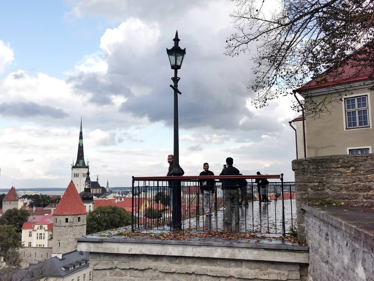 Kohtuotsa Viewpoint in autumn with wet pavement and Tallinn Old Town skyline
