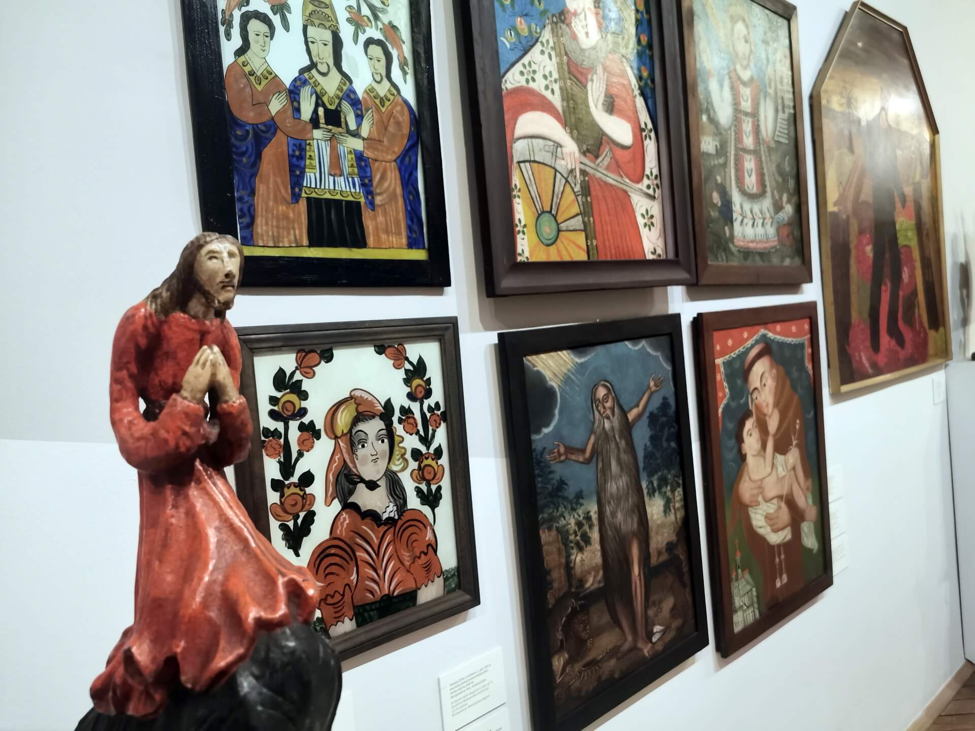 Wall of Polish folk religious paintings and wooden sculpture at the Ethnographic Museum in Krakow
