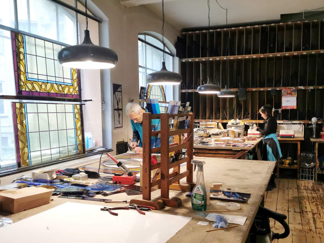 artisans working with stained glass inside Krakow’s historic stained glass museum