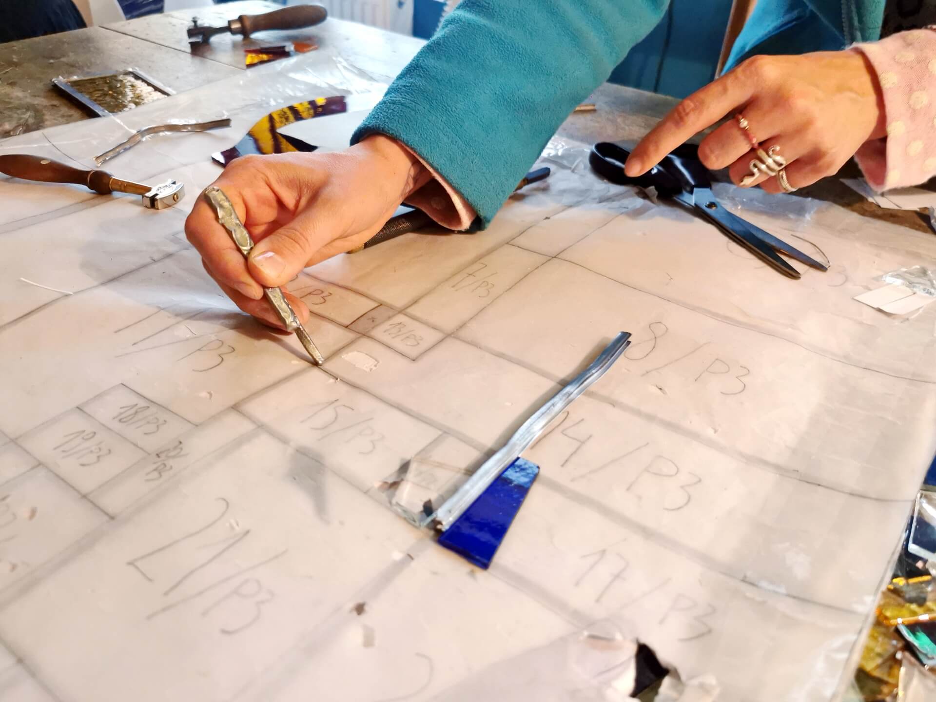 artisan tracing glass templates by hand
